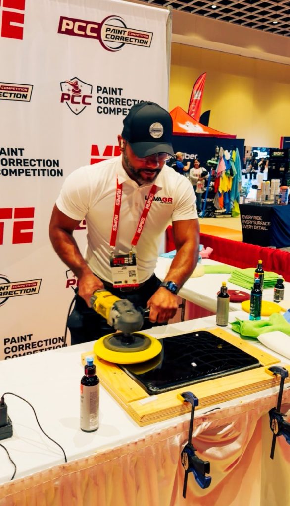 Joseph Stein performing paint correction during a detailing competition at the Mobile Tech Expo