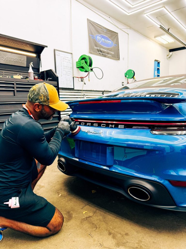 technician polishing a Porsche during professional auto detailing and paint correction at Lava GR Auto Detailing in Wyoming Michigan