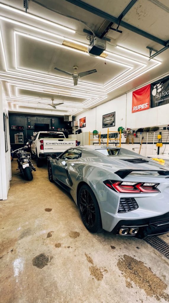 Chevrolet Corvette and motorcycle inside Lava GR Auto Detailing shop